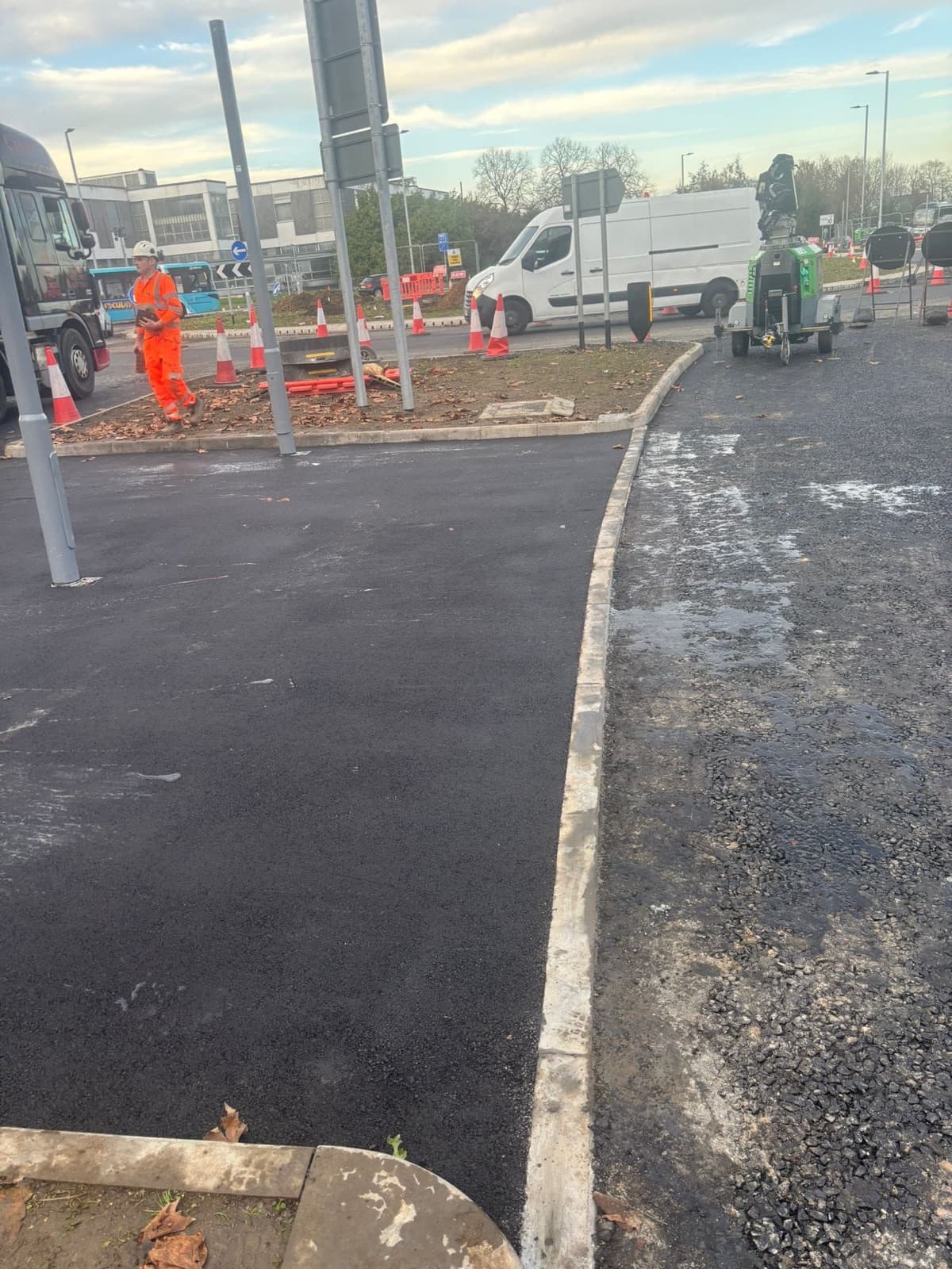 Public-realm surfacing works beside a live road